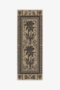 a beige and black rug with two palm trees on the front, one in an ornate border