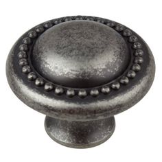 an antique style metal knob with beading on it's end and the top