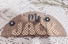 a wooden sign that says,'mr and mrs jack'with flowers on it