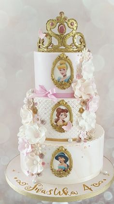 there is a three tiered cake with princess pictures on it