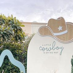 there is a sign that says a little cowboy is on his way in front of the cactus