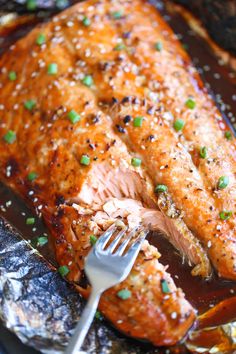 a piece of salmon is being cut with a fork