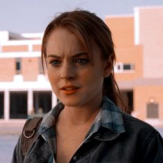 a woman in a black shirt and some buildings