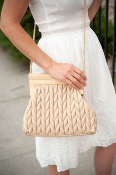 The Rachel quilted clutch is a stylish and versatile handbag that is perfect for an upscale occasion. Featuring a wooden handle closure, this bag is both functional and fashionable, offering a unique and eye-catching design. The soft leather chevron quilting adds a touch of elegance and sophistication to the bag, while the spacious interior provides plenty of room for all your essentials. Whether you're heading to a special event or a casual outing with friends, the Rachel quilted clutch is the Cotton Boho Dress, Quilted Clutch, White Dresses Graduation, The Rachel, White Boho Dress, White Cotton Dress, Chevron Quilt, Cotton Midi Dress, Boho Vibe