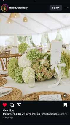 the table is set with flowers and place cards