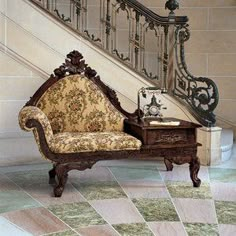 an ornate chair sitting in front of a stair case