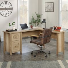 an office desk with a chair, laptop and clock on the wall