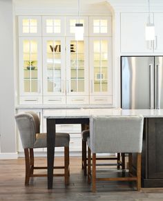 the kitchen is clean and ready to be used for dinner or lunch time, with chairs around the table