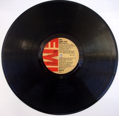 an old black record with the word love on it's side and red lettering