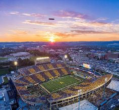 an aerial view of a football stadium at sunset