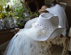 a white hat sitting on top of a chair