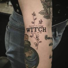 a person with a tattoo on their arm that says, there's a little witch in all of us