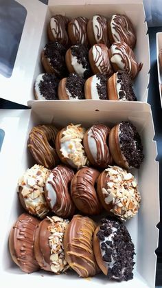 two boxes filled with assorted chocolate covered donuts