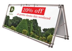 a large sign with the words 20 % off on it and trees in the background