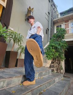 a man standing on steps with his foot in the air