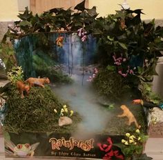 an image of a fake forest scene with animals and plants on it's sides