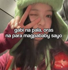 a girl in a green hat making a peace sign with her hand and the words gabi na pal, oras na para magbababababy sayo