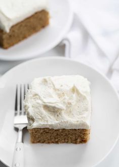 a piece of cake on a white plate with a fork and knife next to it