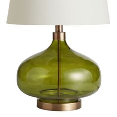 a green glass table lamp with a white shade