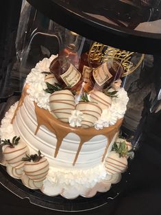 a three tiered cake covered in white frosting and topped with caramel drizzle