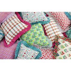 a pile of colorful pillows sitting on top of each other