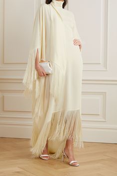 Taller Marmo's 'Mrs Ross' kaftan is inspired by gowns worn by the glamorous diva herself, Diana. Cut from crepe that drapes beautifully, it has satin ties at the high neck and sweeping fringe along the wide sleeves floor-pooling hem. This ivory version is designed for brides and can be worn long after the big day. Nia Core, Dramatic Ethereal, School Moodboard, Taller Marmo, Fashion Collection Inspiration, Net Sustain, Designer Maxi Dress, Modest Wedding Dresses, Top Designer Brands