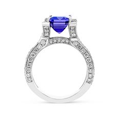 Radiant and romantic, this emerald-cut Blue tanzanite ring will take her breath away. Sparkling for every angle, this ring featuring an emerald-cut blue tanzanite center stone in a sparkling diamond adorned tension setting which flows seamlessly into an embellished split shank. Dazzle your friends and family at every occasion by wearing this unique, feminine, handmade piece.
3.44 carat emerald cut tanzanite
2.30 carat diamond pave setting
18k white gold
Th Gemstone Rings Vintage, Natural Ruby Ring, Tension Setting, Spinel Ring, Cushion Cut Ring, Cushion Ring, Tanzanite Ring, Blue Tanzanite, Sparkling Diamond