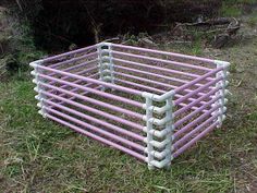 a pink and white basket sitting in the grass