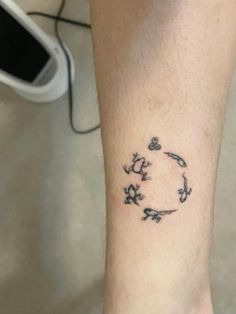 a person with a tattoo on their foot that has birds flying in the air around them