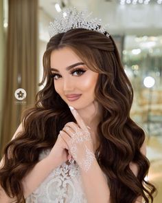 a woman with long hair wearing a tiara