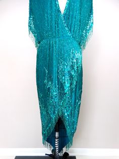 "This is a DAZZLING vintage dress from couture designer to the stars, Bob Mackie. It's completely hand embellished with beading and sequins. It's in excellent condition! Measurements: Bust - 40\" Waist - 30\" Hips - 42\" Length - 31\" in front / 52\" in back This dress comes from a pet-free and smoke-free home. If you would like more info or have any questions, please don't hesitate to ask!" Turquoise Evening Dresses With Sequins, Elegant Turquoise Sequin Dress, Turquoise Embellished Dress For Wedding, Turquoise Embellished Wedding Dress, Iridescent Dress, Dress Art, Green Gown, Gown Photos, Bob Mackie