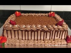 a cake with chocolate frosting and strawberries on the top is sitting on a counter