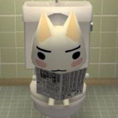 a toilet with a cat face on the lid and newspaper in it's mouth