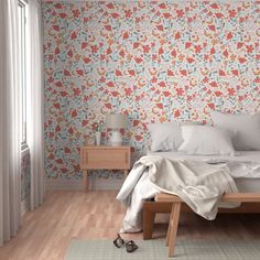 a bed sitting in a bedroom next to a wooden dresser and lamp on top of a hard wood floor