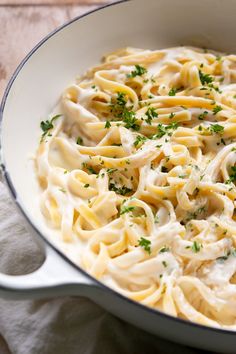 a pan filled with pasta and sauce on top of a table