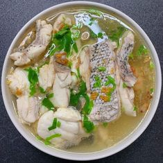 a white bowl filled with meat and vegetables