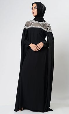 It is sweeping cape-style Nida Abaya Dress and hand embroidery set across the d‚Äö?†??¬¨¬©collet‚Äö?†??¬¨¬© of the bodice then falls at the front and back at upper yoke, lined with satin and net at upper bodice East Essence featuring a round neck, Full sleeves with side cape, a back zip fastening. Classic Craftsmanship details.A fully lined abaya with perfect designer hijab. *Hijab Included* FIT: Relaxed COMPOSITION: Nida CARE: Dry Clean Cape Abaya For Evening And Eid, Elegant Black Cape Abaya, Black Khimar For Wedding And Eid, Evening Black Abaya With Dabka, Designer Hijab, Side Cape, Black Cape, Cape Style, Don't Compare