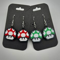 These cute and colorful pixel-style Mario mushroom earrings are 3d printed in PLA plastic, with stainless steal nickel-free hooks attached. Each side is around the size of a quarter (see second photo for a comparison). Thanks for looking! Pink Games, Mushroom Earrings, Coin Earrings, Stainless Steal, Cat Earrings, Mario Mushroom, Acrylic Earrings, Light Weight Earrings, Heart Earrings