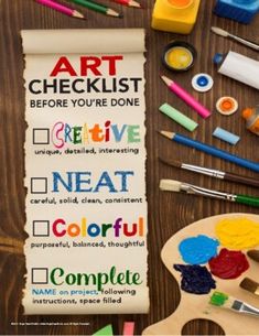 an art checklist is displayed on a wooden table with paint and crayons