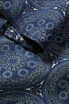 the fabric is blue and white with an intricate design on it's back side