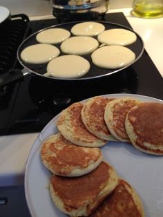 pancakes are on a plate next to a stove