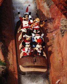 several mickey mouse figurines are lined up on a roller coaster