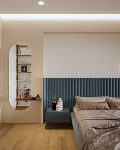 a bedroom with a blue headboard and wooden flooring next to a white wall