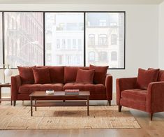 a living room with two couches and a coffee table in front of large windows