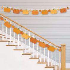 an orange garland is hanging on the banister