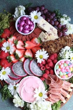 a platter filled with fruit, cheese and other foods