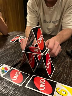 a man sitting at a table with several stickers on it and one has his hands in the center