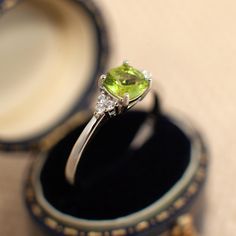 A Peridot Silver Ring for Women. Meticulously crafted in 925 Sterling Silver, this piece features a natural Peridot adorned with CZ stones on the sides. It serves as both a meaningful birthstone birthday gift and an affordable option for an engagement ring. Additionally, it makes for a cherished anniversary gift. These dainty stacking rings, delicately designed, feature a prominent 6.6mm stone. Notably, the ring is nickel-free and hypoallergenic, ensuring comfort and style for all. DETAILS * Mat Peridot Birthstone Ring, Silver Rings Engagement, Peridot Birthstone, Minimalist Engagement Ring, Promise Ring Gift, Unique Handmade Jewelry, Ring Promise, Green Gemstones, Birthday Gifts For Women