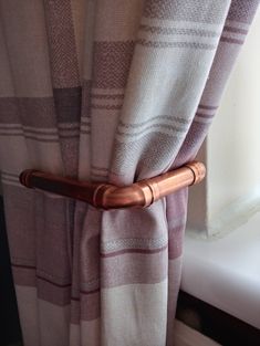 a curtain with a wooden handle attached to it