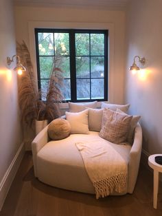 a living room with a white couch and pillows